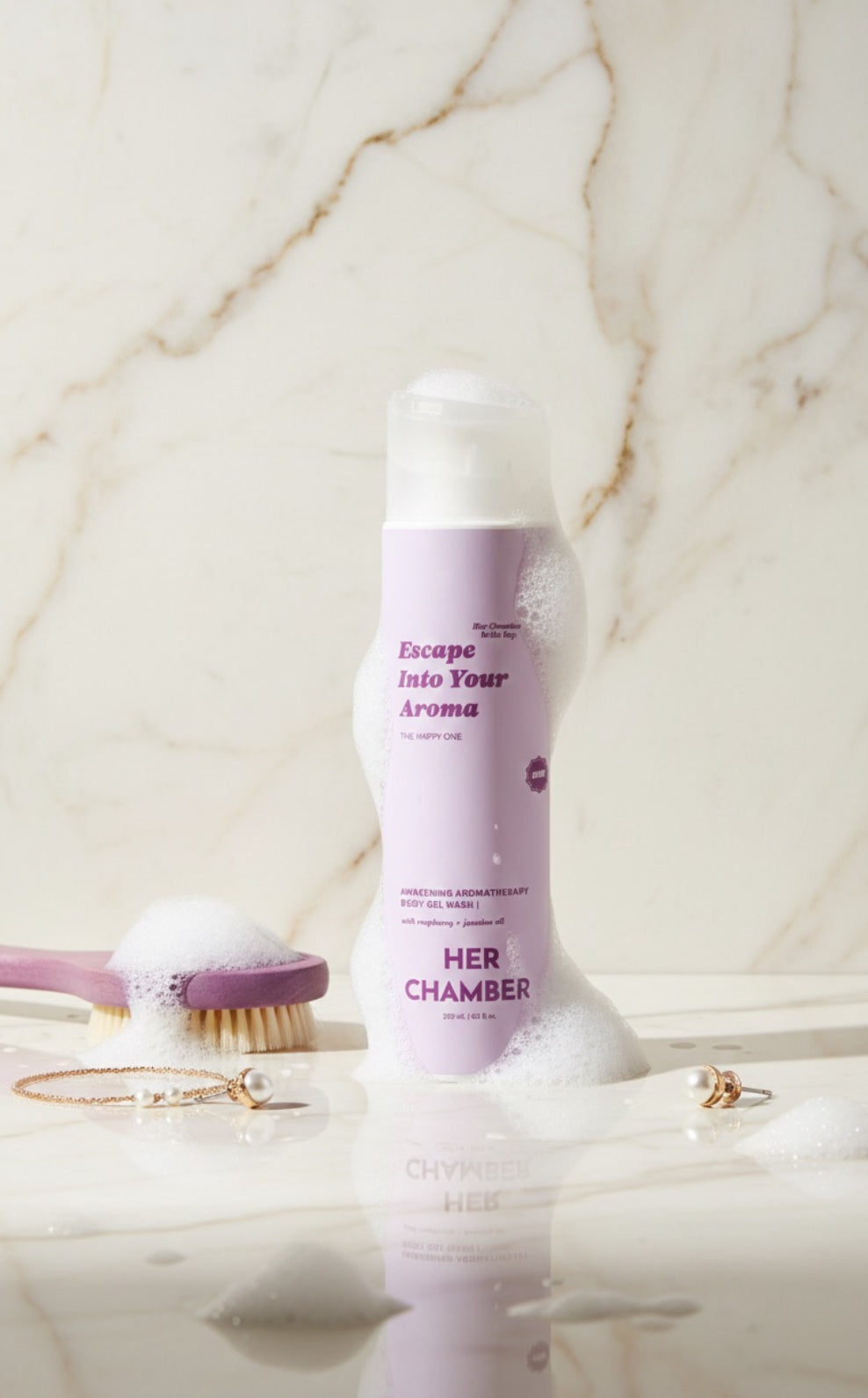 Product labeled 'Her Chamber' on a marble surface with a brush and other items.