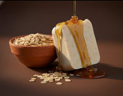 Decorative soap with honey and oats on a brown background